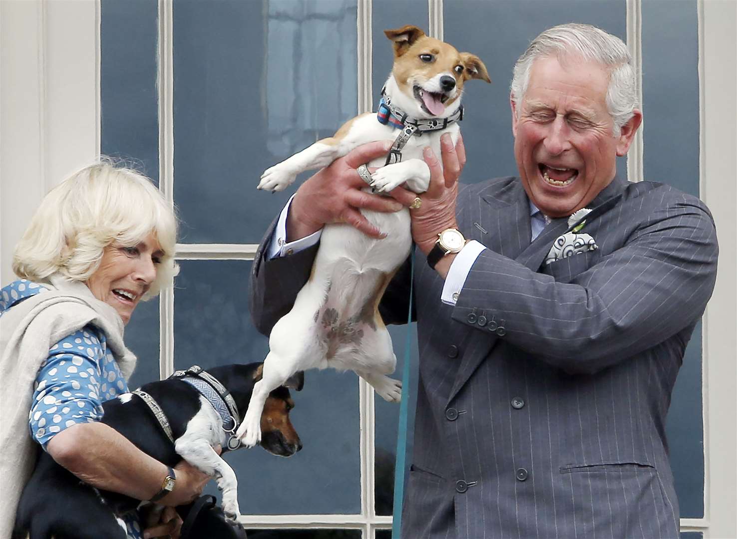 The Duke and Duchess of Rothesay, as they are known in Scotland, holding Camilla’s dogs Beth, left and Bluebell in 2015 (Danny Lawson/PA)