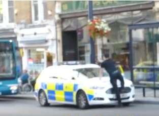 Discoboy climbed onto a police car