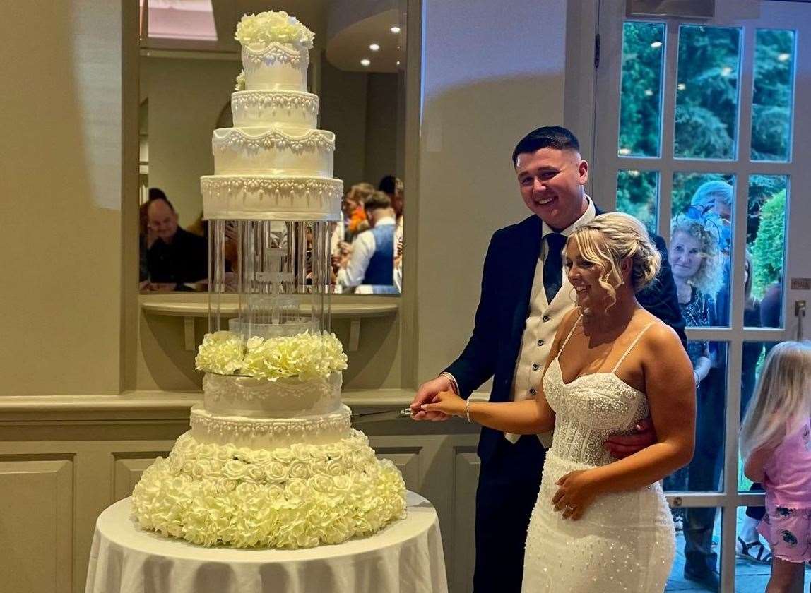 Pash and Charlie cut their wedding cake on their big day