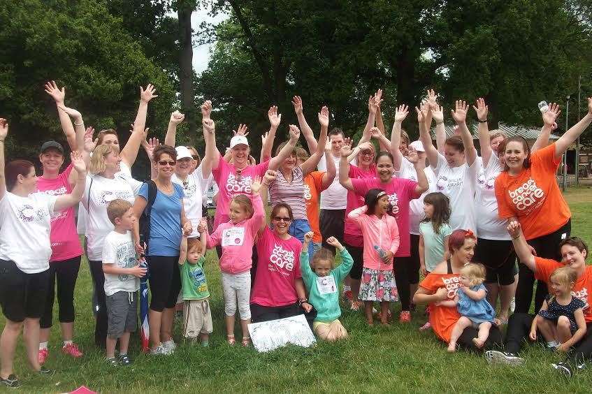 Sarah Bourne (bottom centre) and her friends and colleagues celebrate the end of the 26-mile sponsored walk