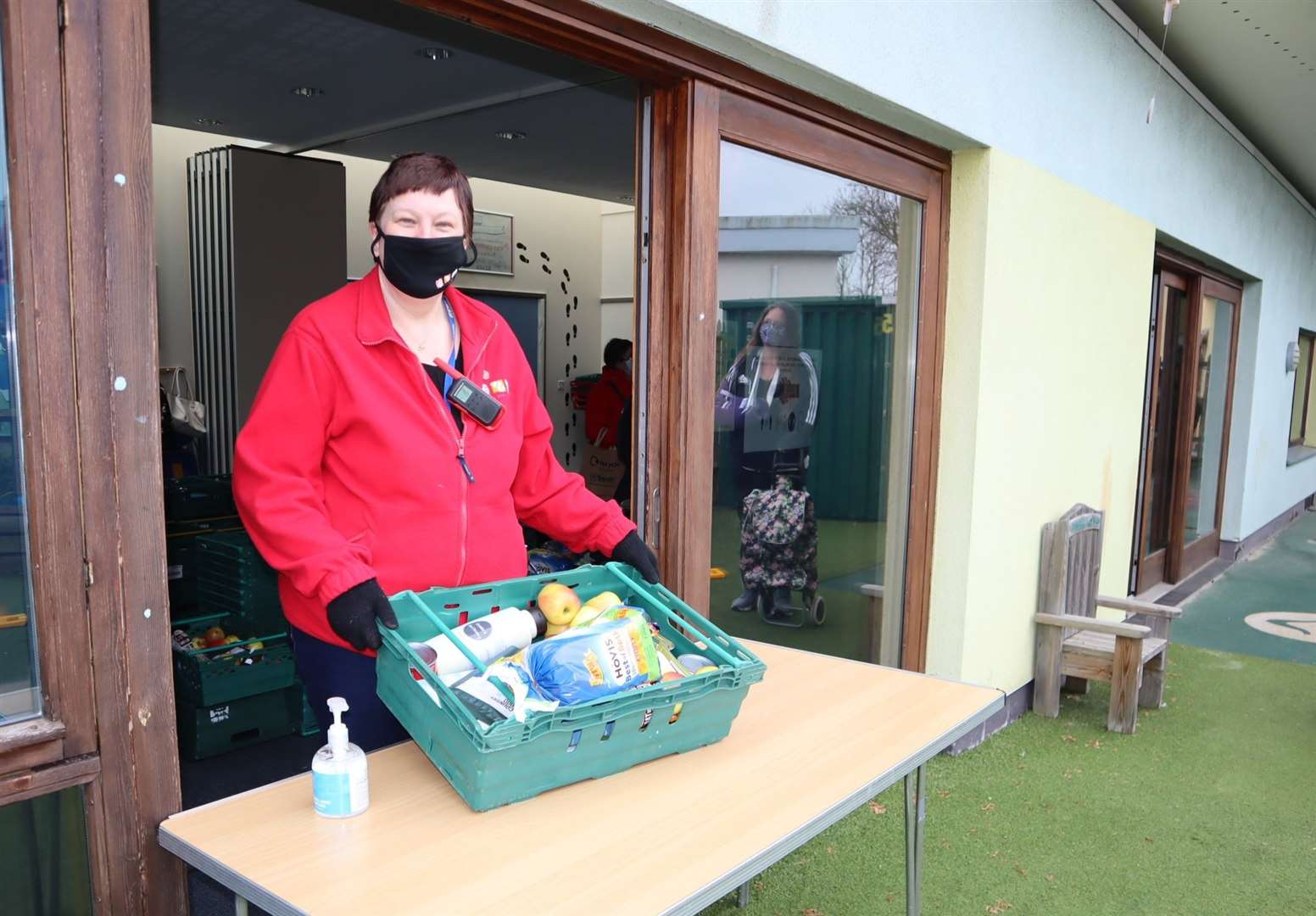 Gaynor O'Sullivan, who is managing the Kent Community Pantry, at the serving hatch at Seashells children and families centre in Rose Street, Sheerness