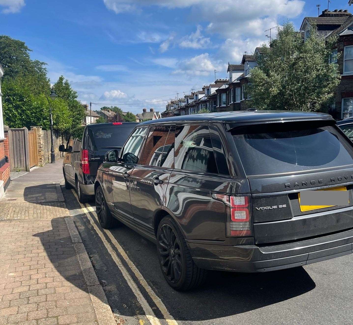 Cars parked on double yellow lines in Roebuck Road, Rochester