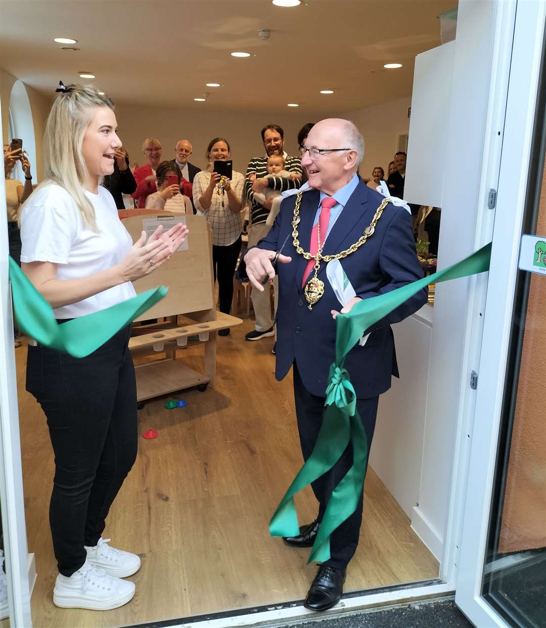 The Mayor Cllr Gordon Newton cuts the ribbon assisted by the nursery manager Penny Reidy