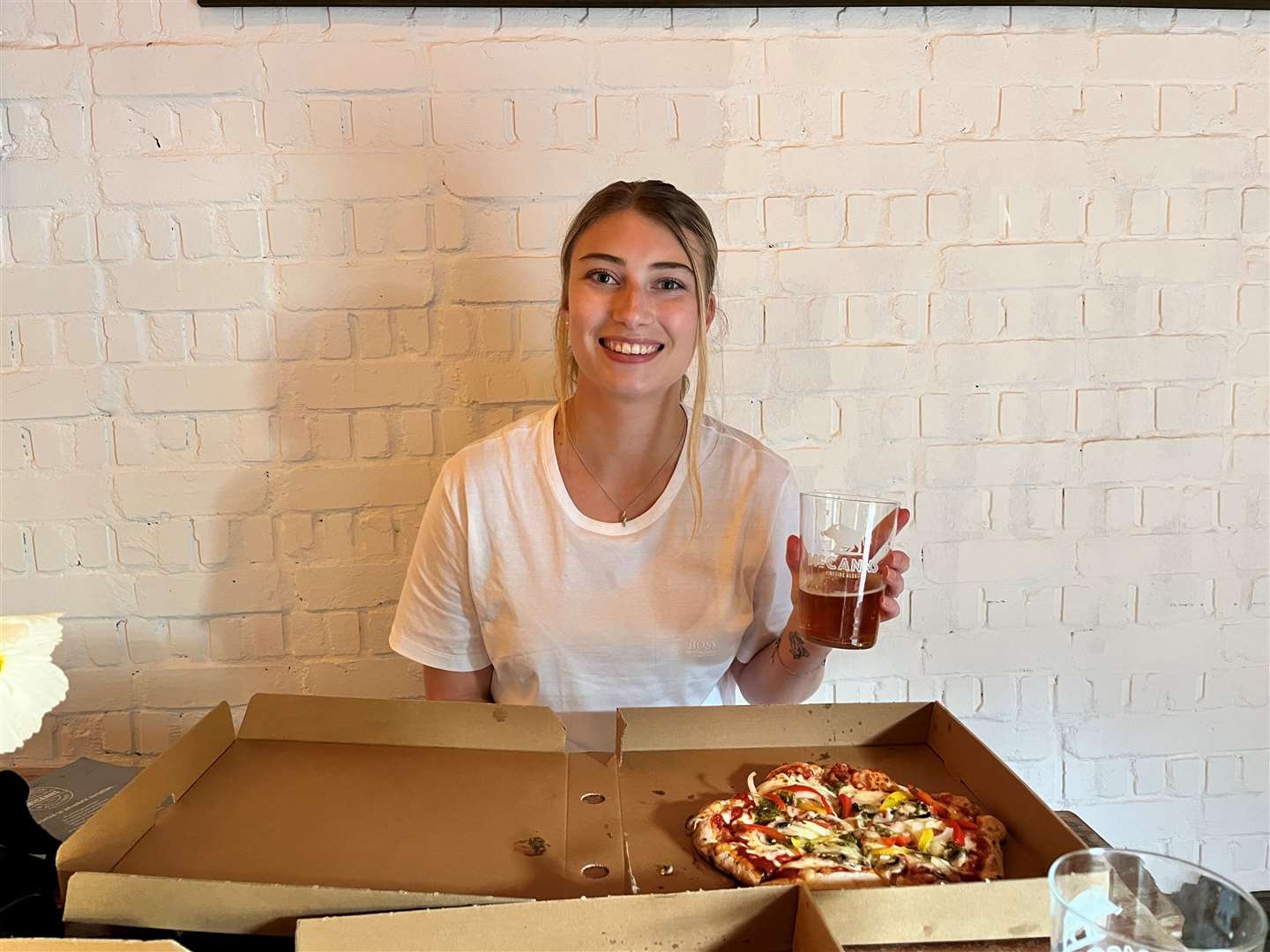 Reporter Chantal Weller enjoying a pizza and McCanns brewed beer