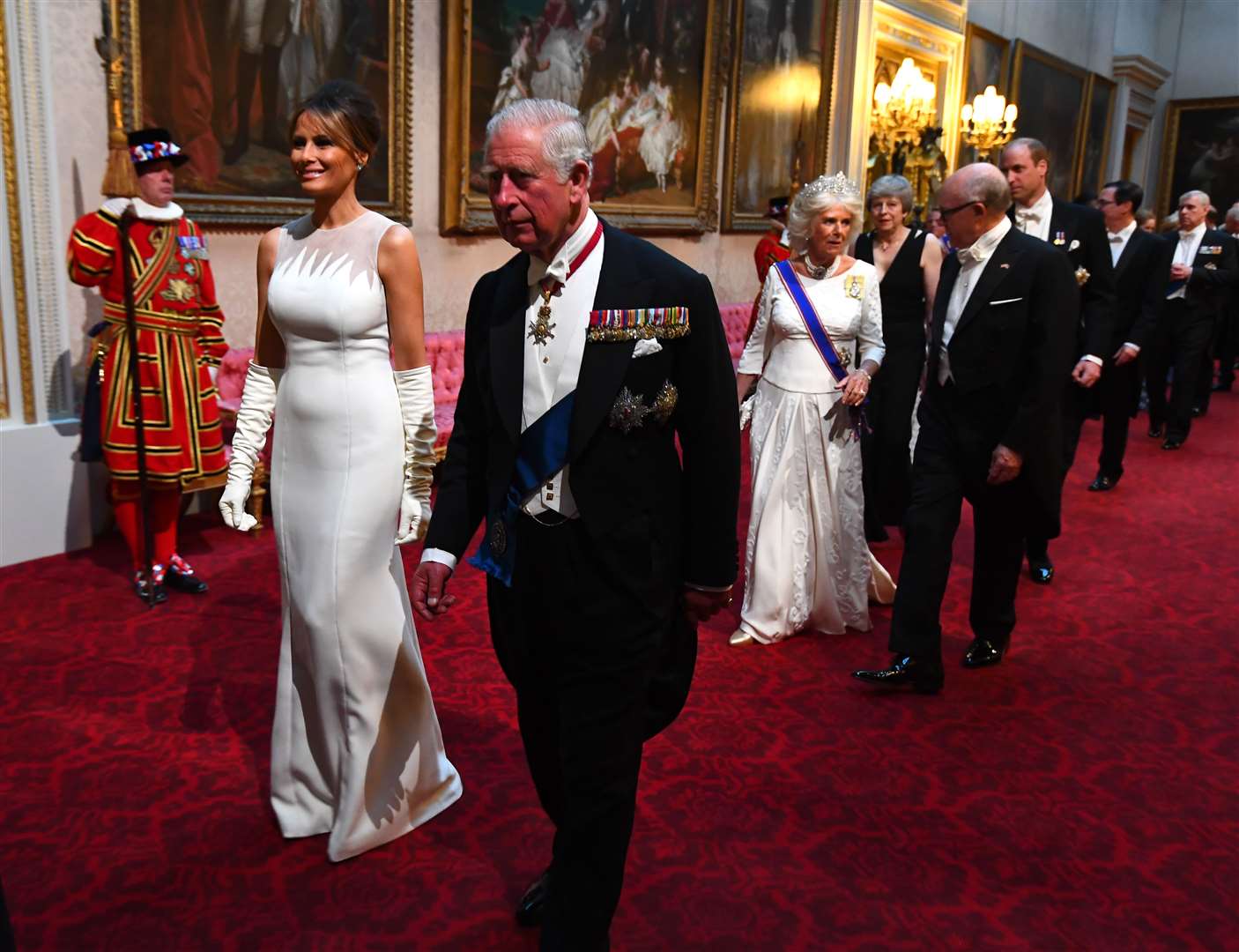 Melania Trump and the then-Prince of Wales arrive through the East Gallery during the State Banquet at Buckingham Palace (Victoria Jones/PA)