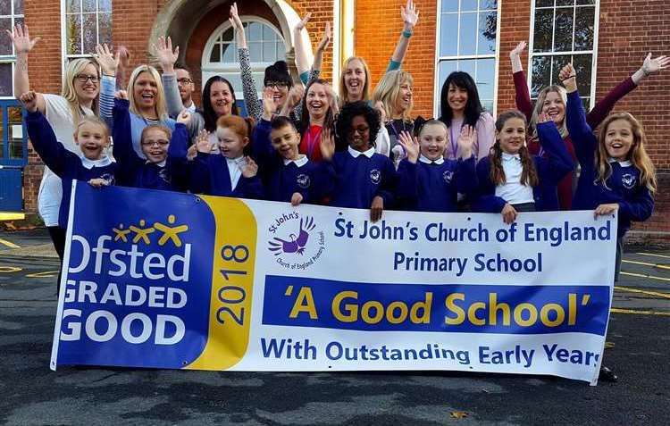 Pupils and staff celebrating a school's 'Good' Ofsted rating in 2018. Library image