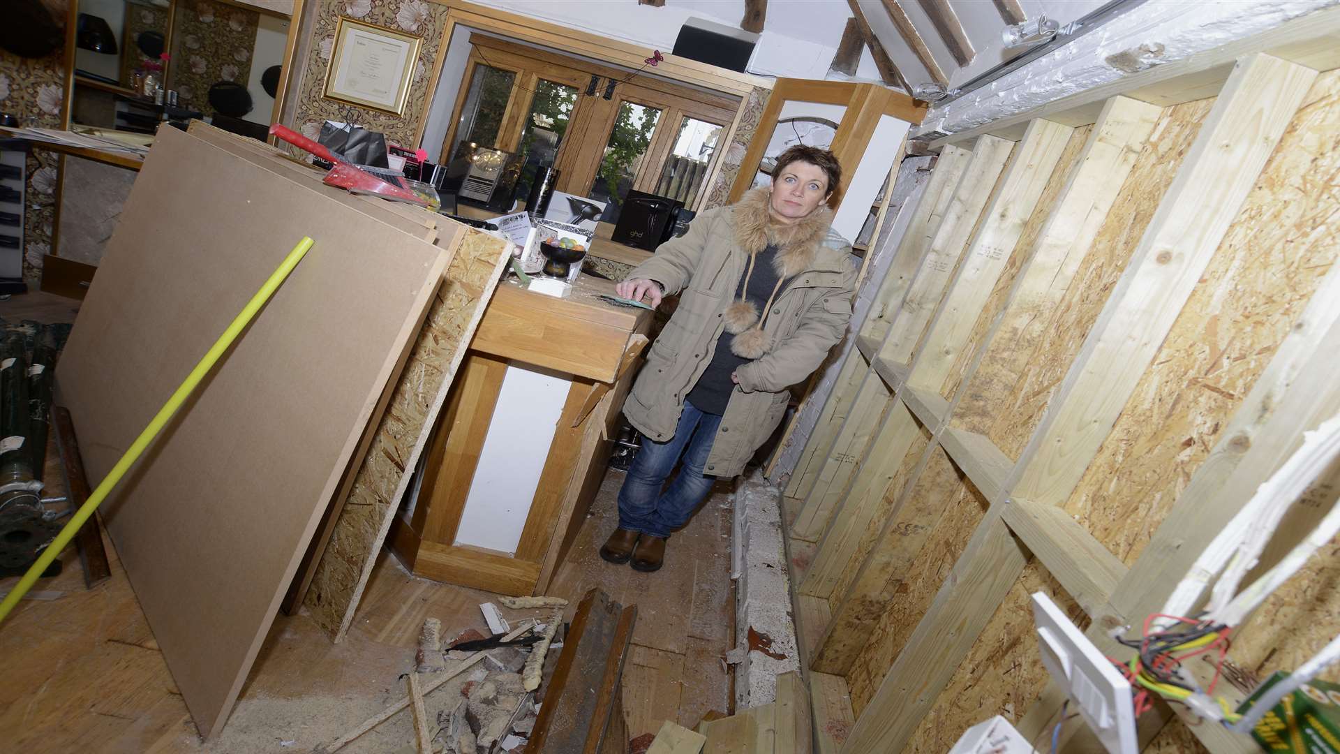 Owner Jenny Taylor by the boarded up window that the car ploughed into