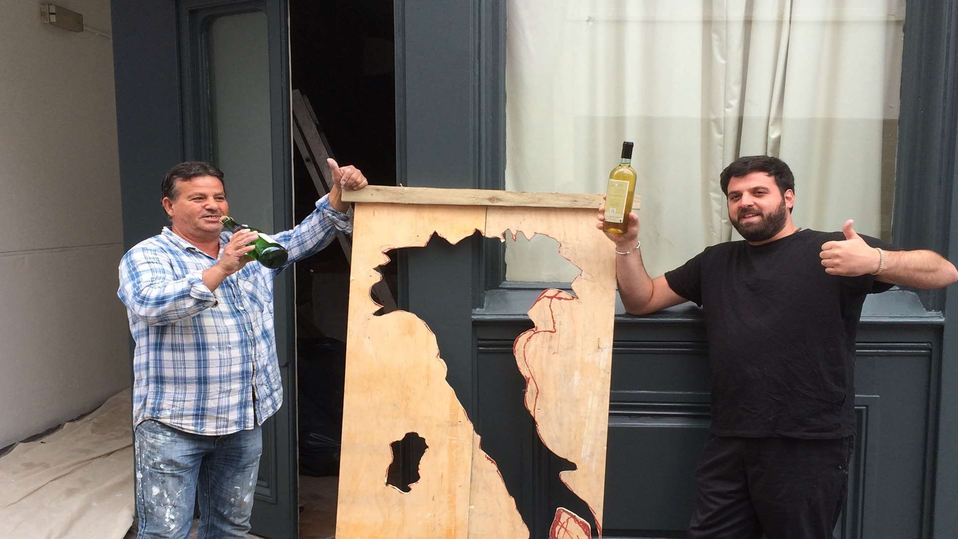 Virgino Ficetola stands outside his winebar with decorator Domenico Cossari