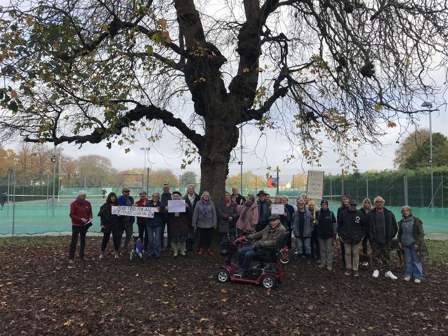 Residents gather by the tree in numbers to show their anger