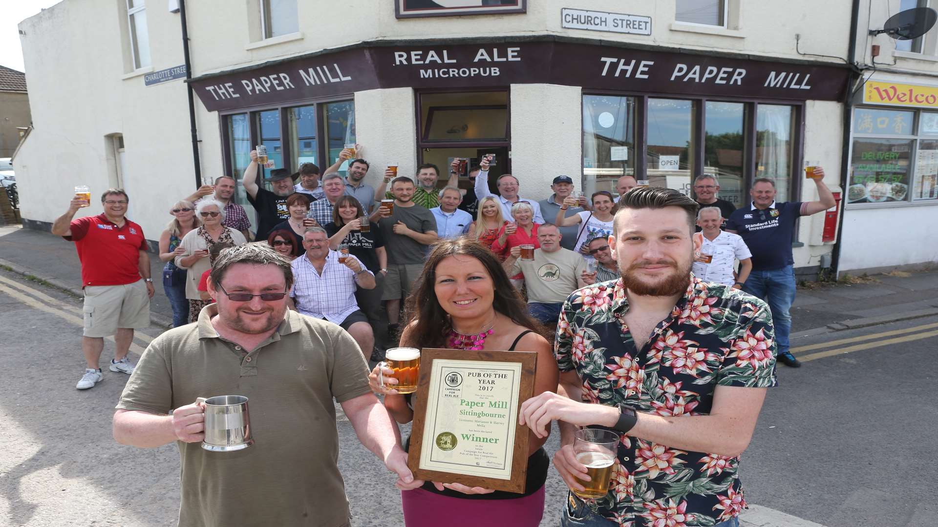 Paul Irving, Chairman of Swale CAMRA awards Marianne Melia and her son Harvey who are the landlady and landlord of The Paper Mill Micropub, anaward for the best Micro-pub for the third year running