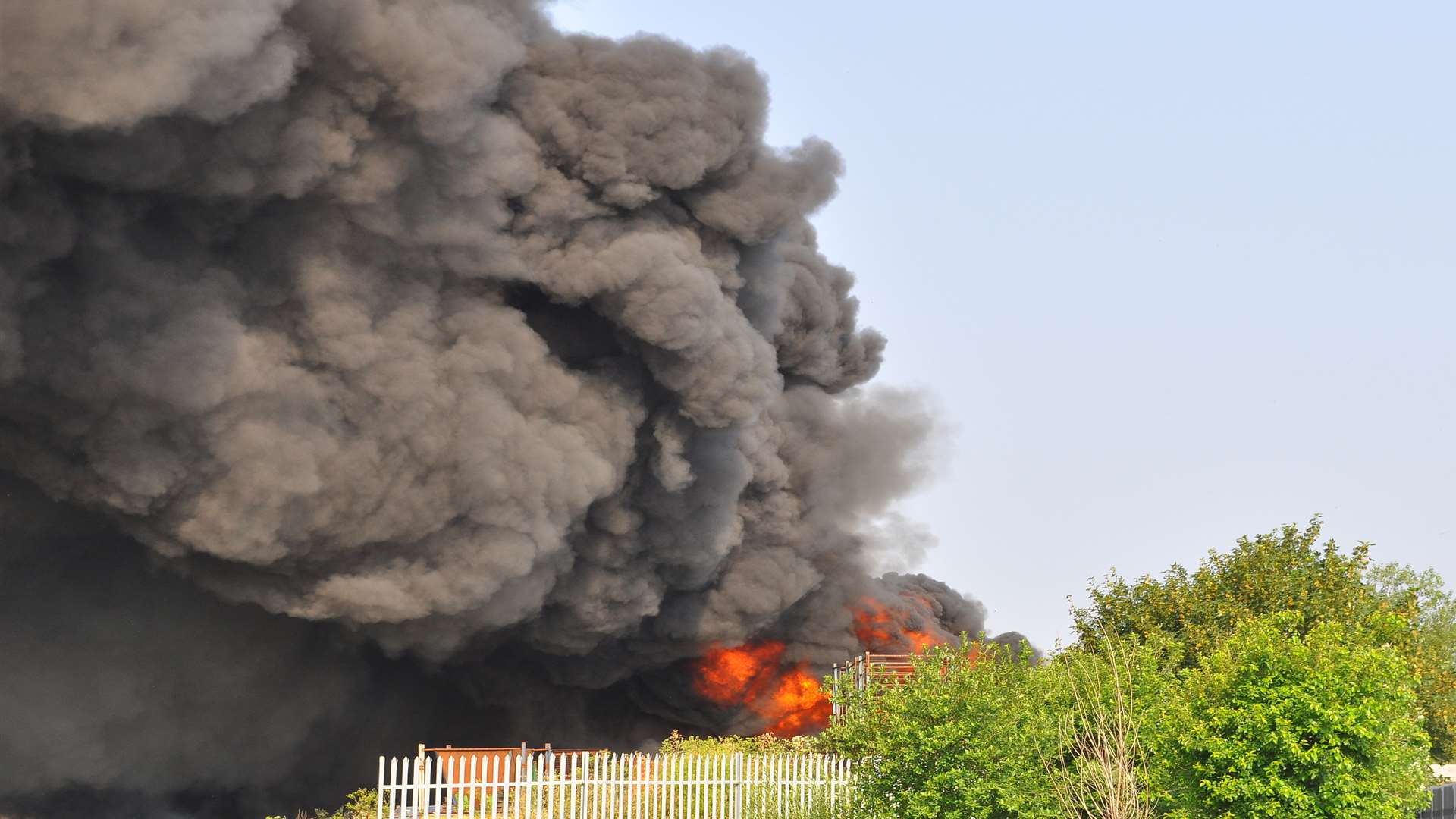 A plume of black smoke billows from the site. Picture: Andy Ives