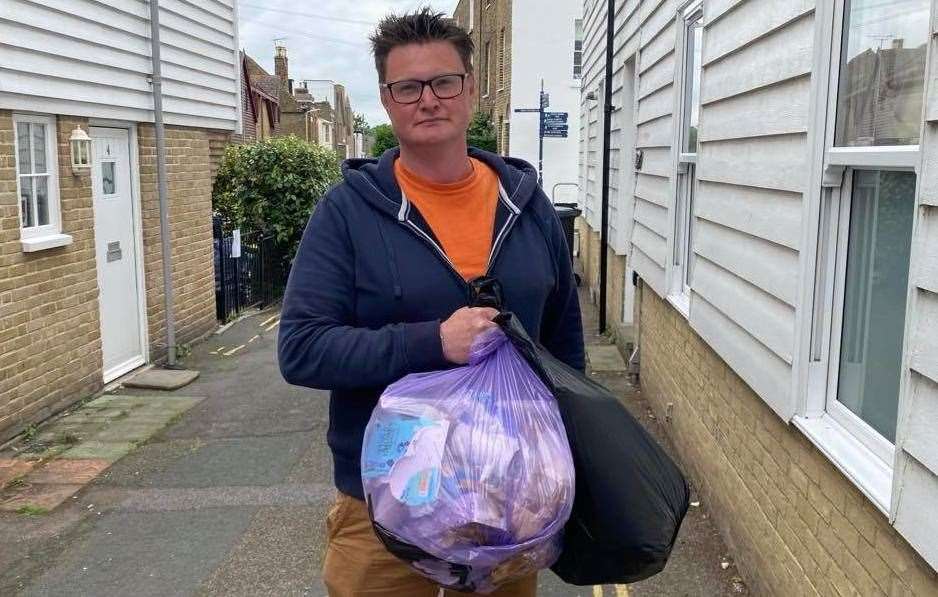 Cllr Chris Cornell with a purple rubbish sack