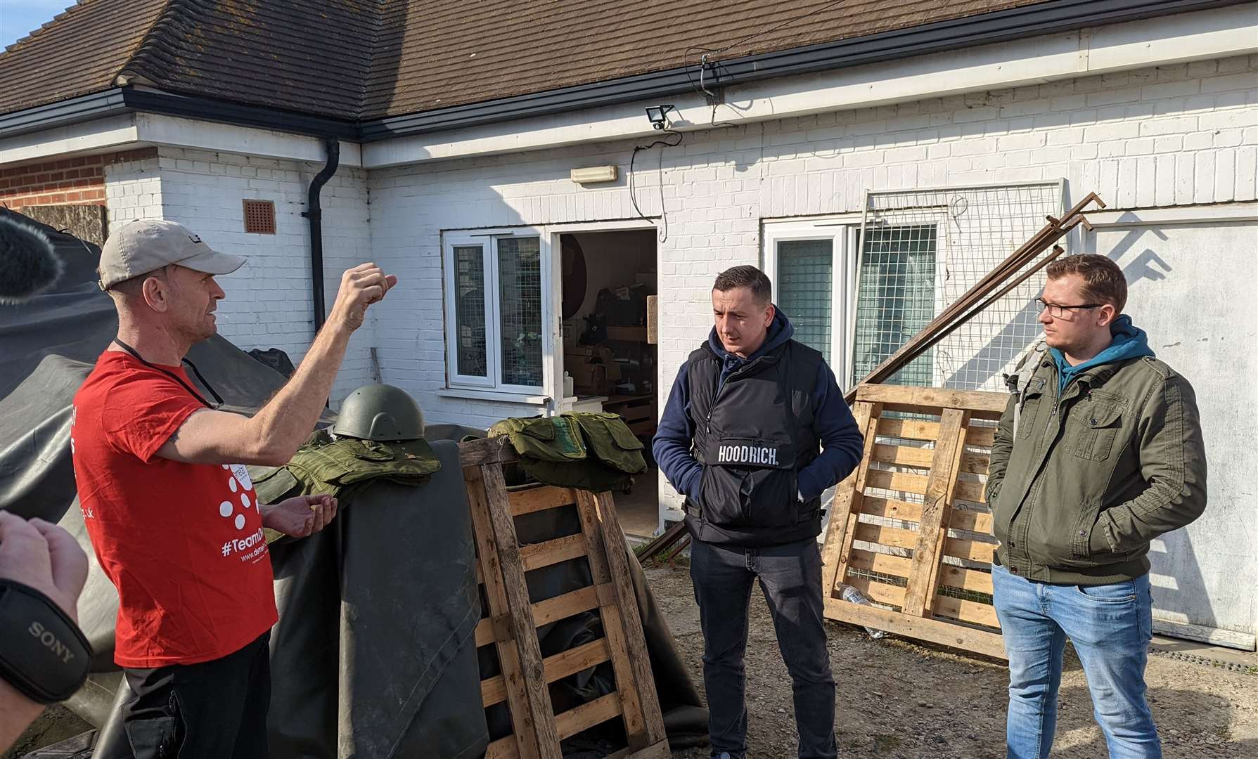 Wozza, left, speaks to the Ukrainians who have travelled to Folkestone