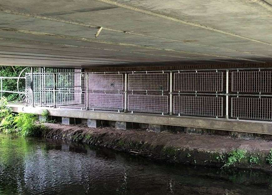 The new fencing put up by Berkeley Homes is aimed at stopping people climbing around the gates and under the bridge