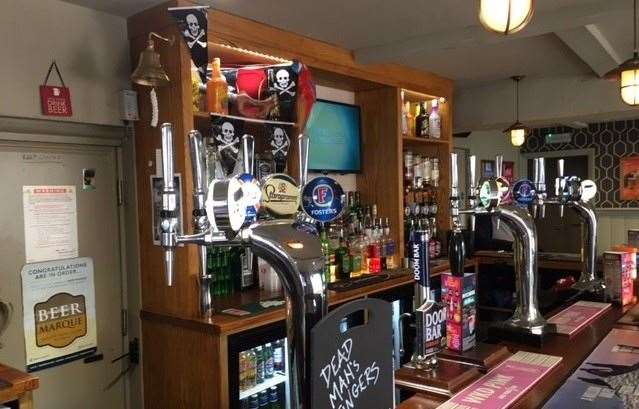 Left over from Pirates’ Day, the skull & crossbones still flutters on the flagpole and the bunting promoting Dead Man’s Fingers is still hung behind the bar