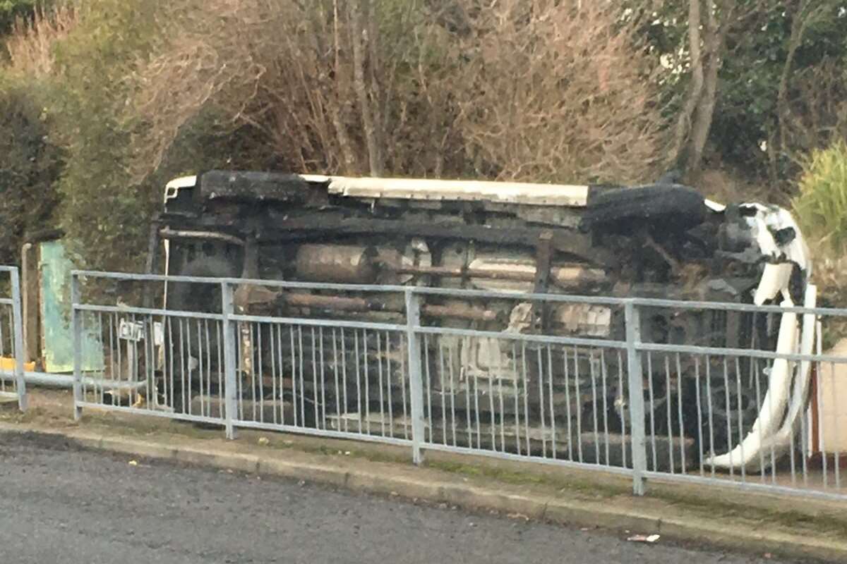 The van has been left on its side and yellow temporary fencing replaces the railings it ploughed through