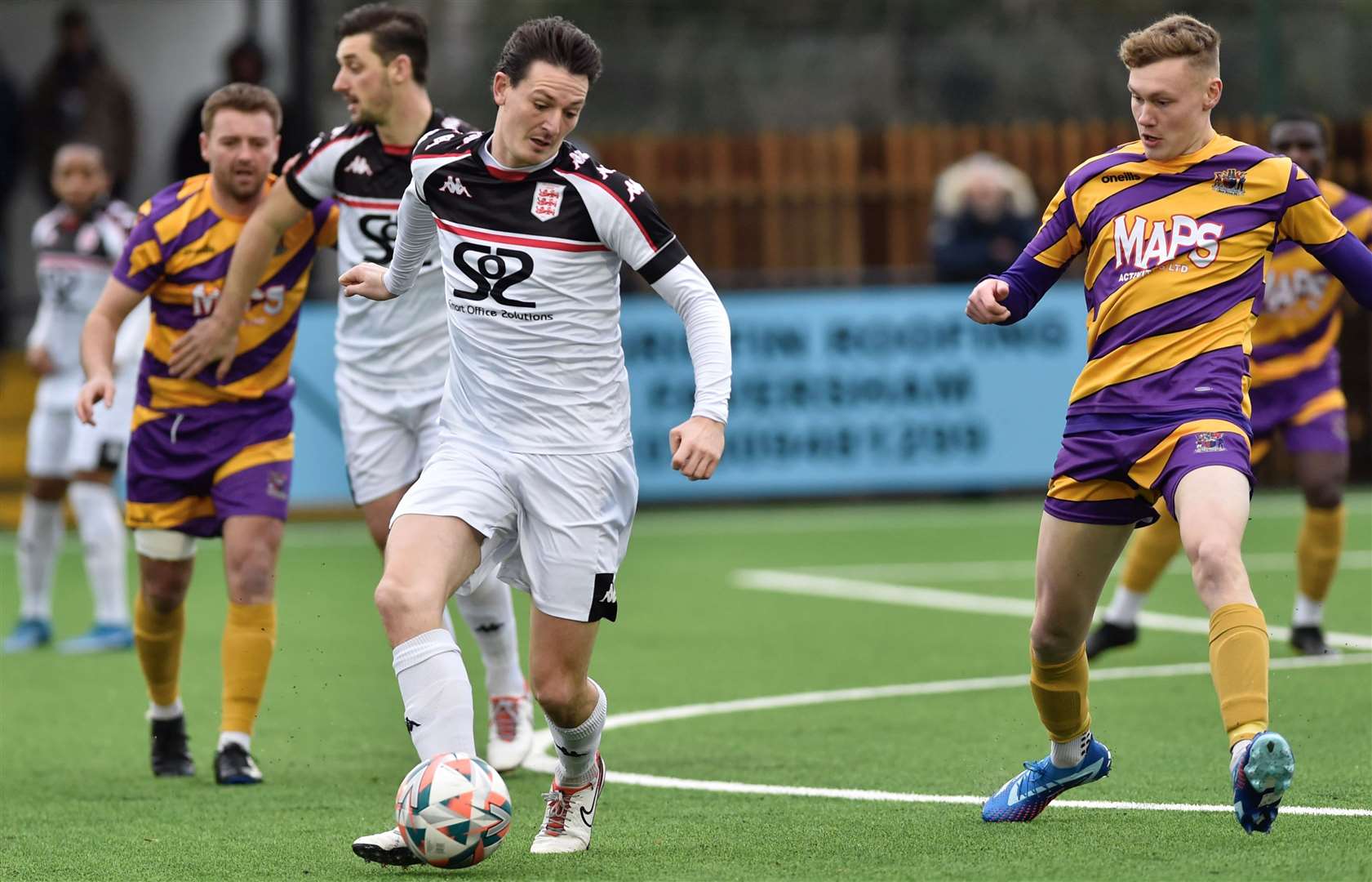 Billy Bennett, of Faversham, passes ahead of Deal defender Alex Green. Picture: Ian Scammell