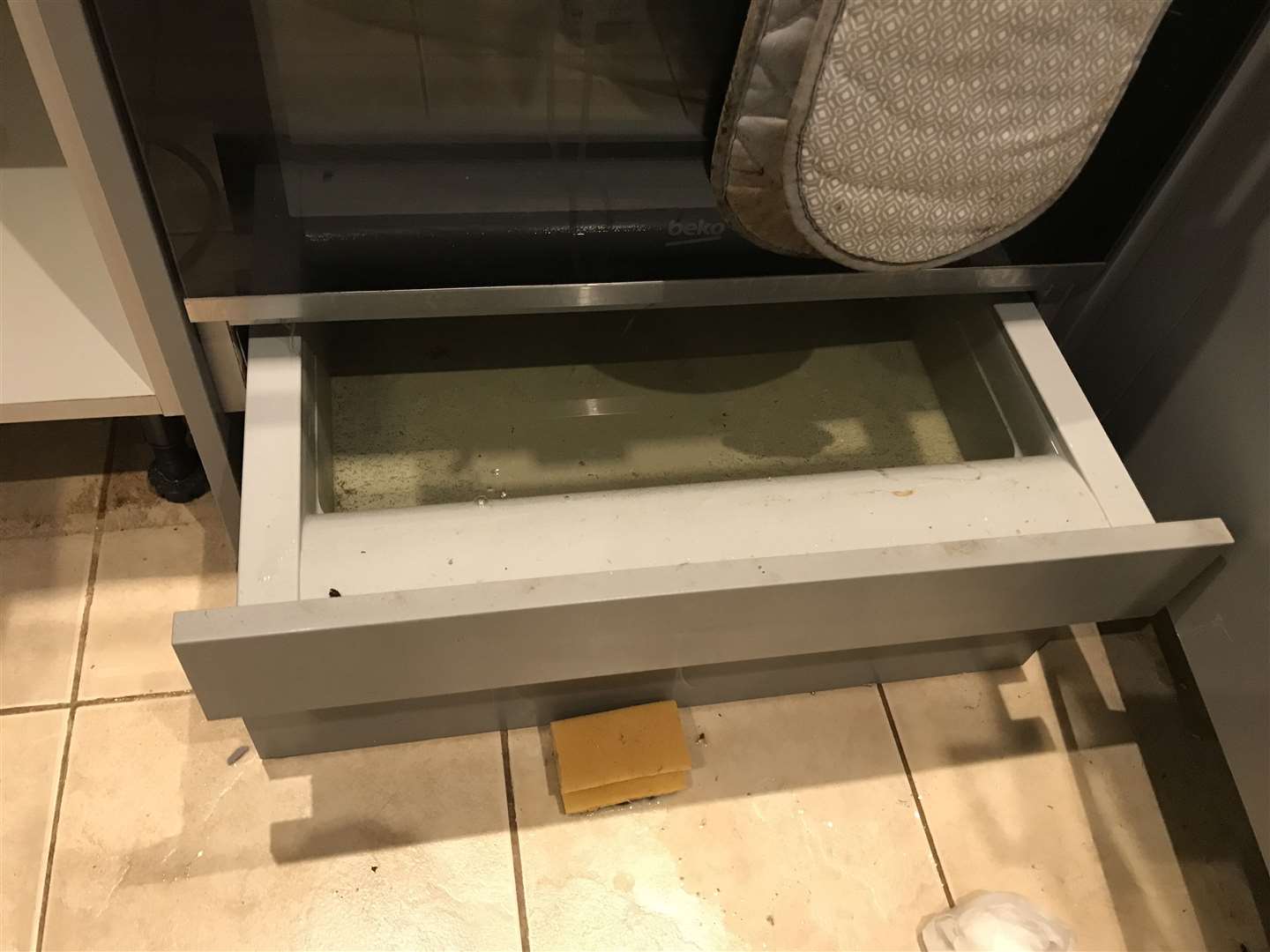 More than three weeks after the flood, water still sits in drawers in the flat