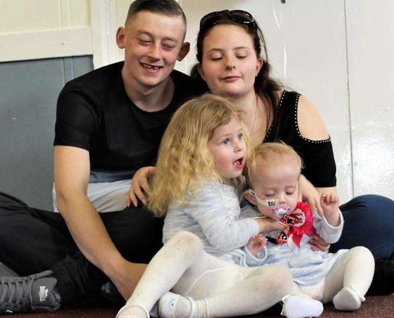 Natalie-Rose with her sister, Ruby-Shel in front of father Nathan Denney and mum Shannon Hook