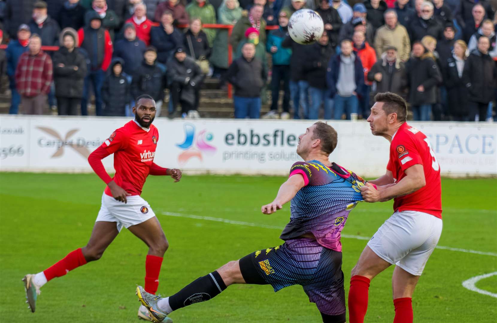 Ebbsfleet's Joe Martin gets to grip with Bromley striker Michael Cheek at Stonebridge Road. Picture: Ed Miller/EUFC