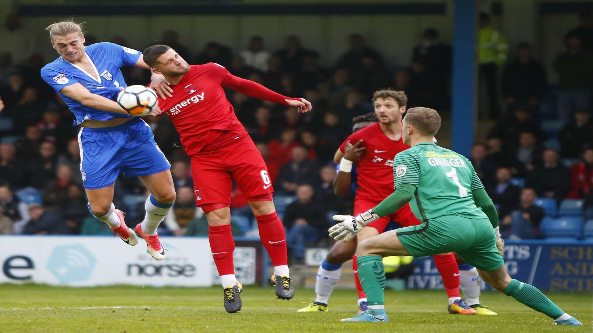 Tom Eaves has his shirt pulled as he tries to get on the end of this cross Picture: Andy Jones