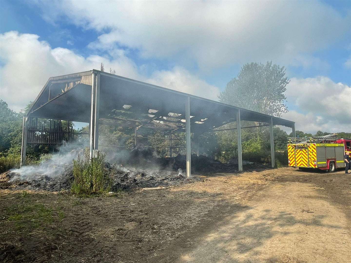 Fire crews remain at the scene in Halden Lane, near Tenterden. Picture: Edward Barham