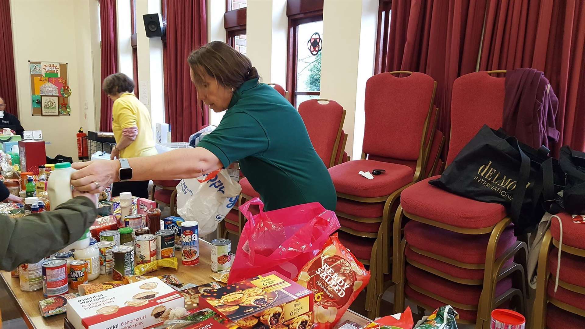 Volunteers hand out additional items to food bank users