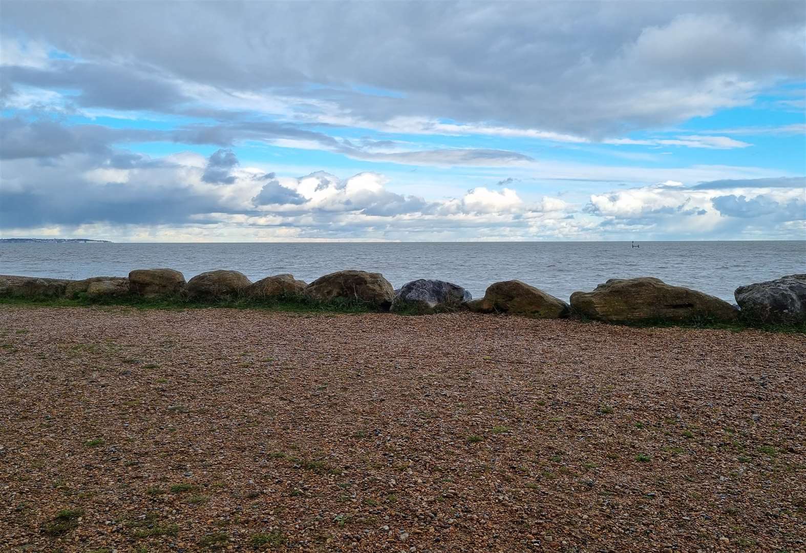 The path runs alongside the sea