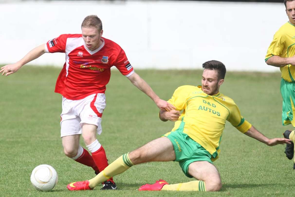 Whitstable's Scott Heard shakes off an Ashford challenge during Saturday's friendly at Belmont. Picture: Matt Bristow