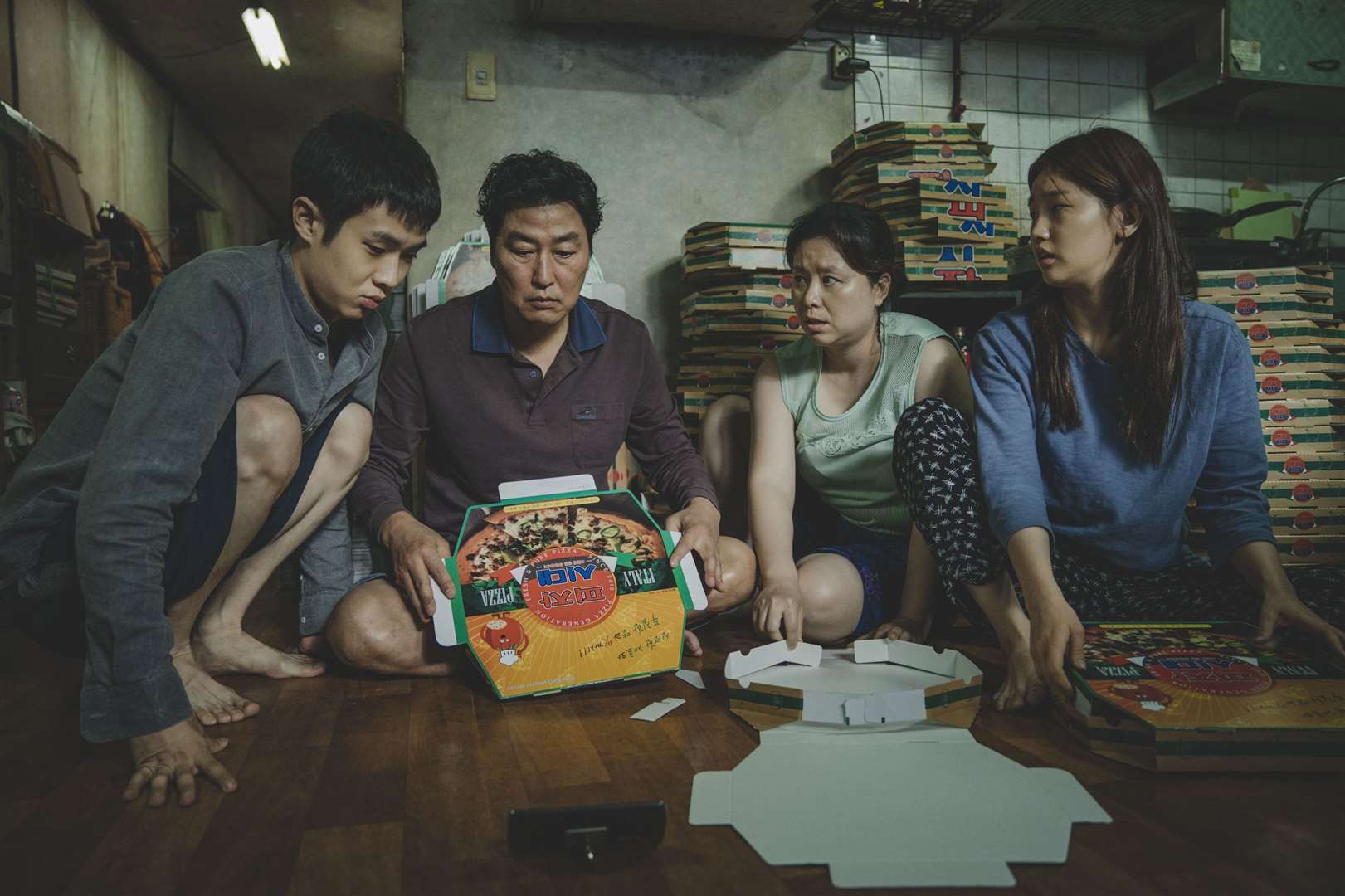 Choi Woo-shik as Kim Ki-woo, Song Kang-ho as Kim Ki-taek, Chang Hyae-jin as Kim Chung-sook and Park So-dam as Kim Ki-jeong. star in Parasite Picture: Curzon Artificial Eye