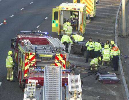 Fire crews cut two people from a crashed car on the M20. Picture: Martin Apps