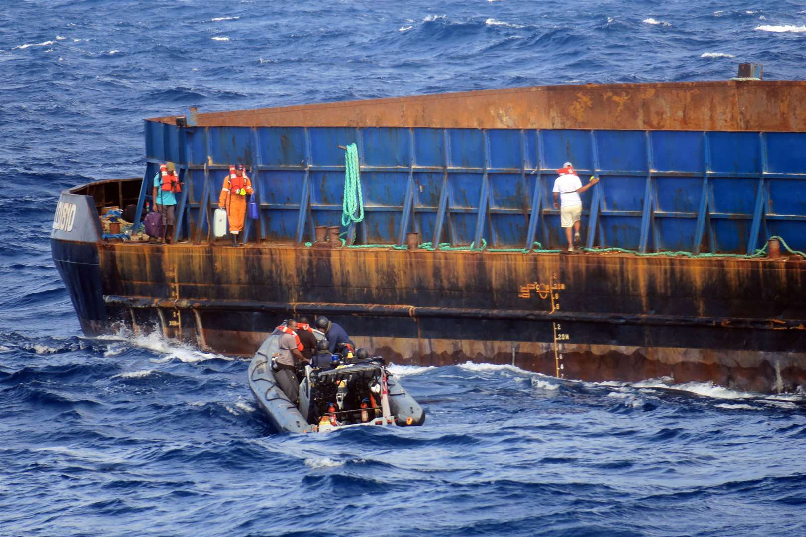 The crew of the tug boat await rescue from HMS Medway's sea boat. Photo: Royal Navy