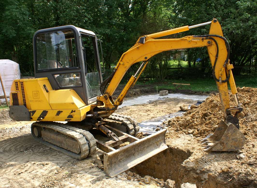 The digger's bucket ended inches from the little girl's head. Stock picture