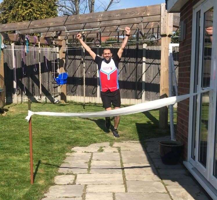 James reaches the finish line made of toilet roll.