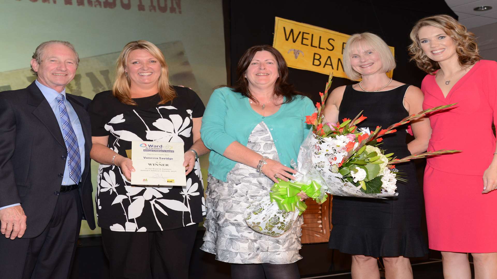 Charlotte Hawkins, Paul Rooney, owner of Ward and Partners, and Carole Lynch presenting an award to Vanessa Savage and Caroline Ford from Holding On Letting Go charity