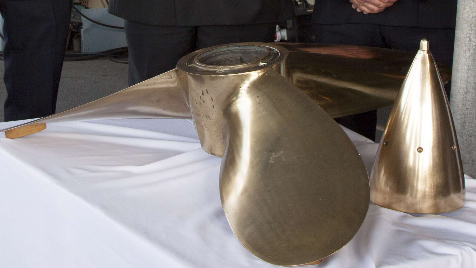 The propeller was handed back to the German Navy by (from left) PC Preston Frost, MCA enforcement officer Simon May and PC Darren Reed in Portsmouth. Picture: BAE Systems