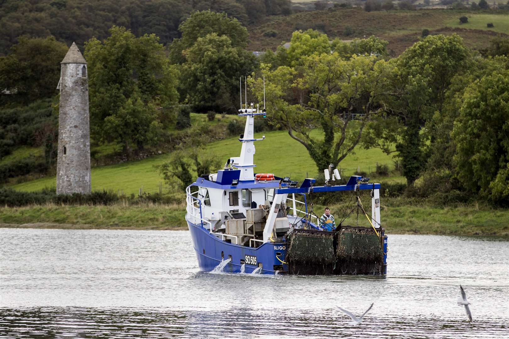 A trawler hauls in its catch as it travels along the invisible border at Narrow Water, between the shoreline of the United Kingdom and Ireland (Liam McBurney/PA)