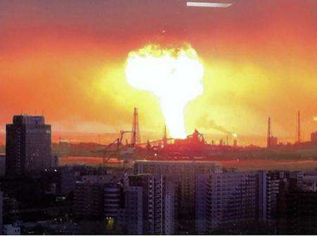 A fireball erupts above the night skyline after an earthquake hits Japan