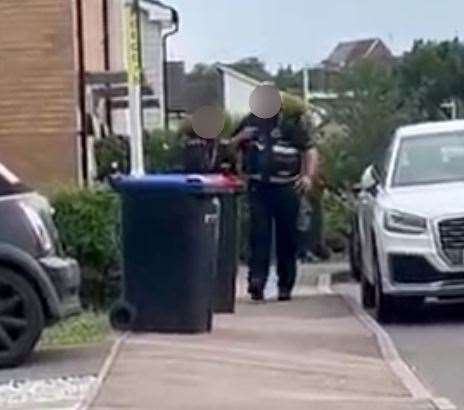 Two parking wardens return from handing out a parking ticket