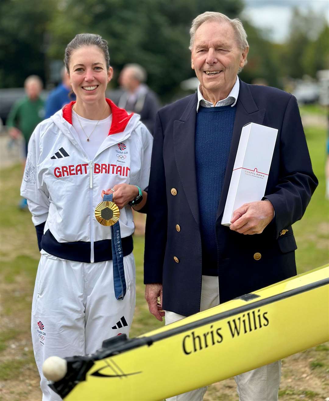 Emily Craig with her Olympic gold medal alongside Bewl Bridge Rowing Club founder Chris Willis with the boat named after him