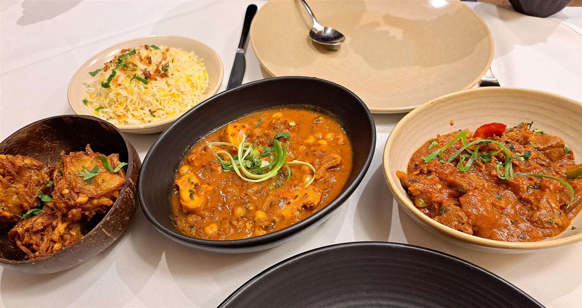 From left: onion bhaji, pilau rice, Zeera chicken and Shaktora Ghoast from Indi18 in Tonbridge. Picture: Nikki White