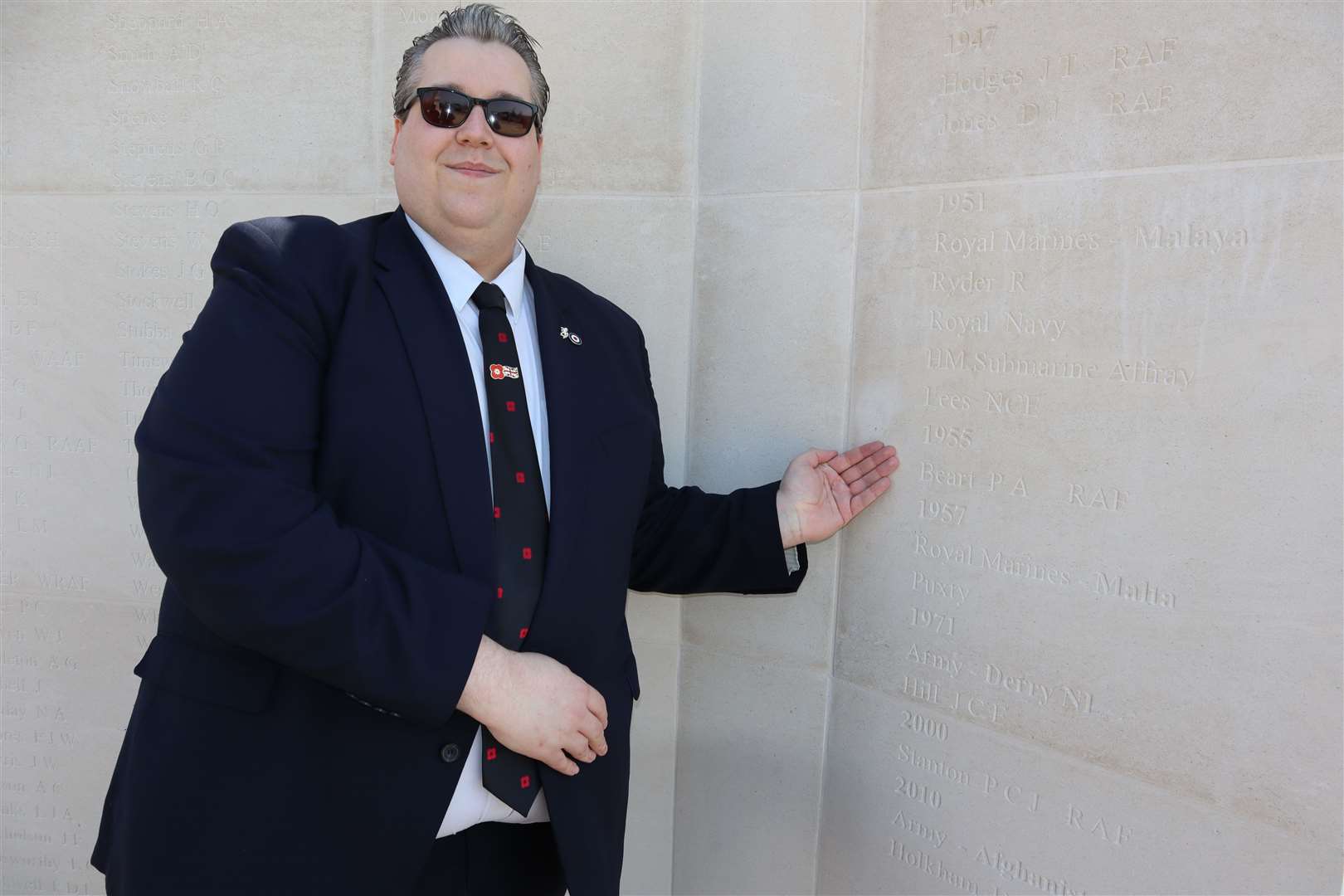 Cllr Cameron Beart points out the name of his great uncle Percy Albert Beart, who died in 1955 when his helicopter crashed in Scotland, at the dedication ceremony for the new memorial wall at Sheerness war memorial on Sunday