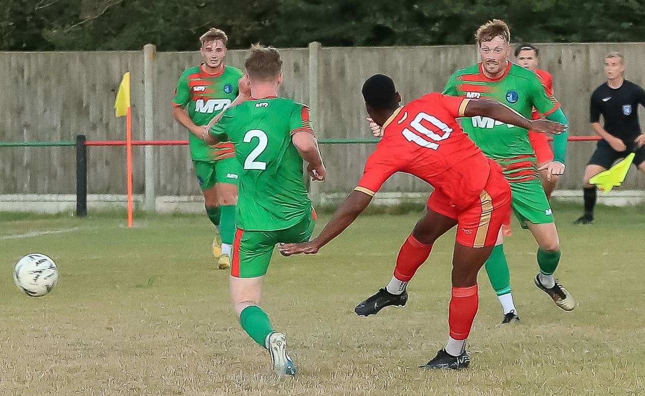 Striker Jerson Dos Santos scores Whitstable’s first goal at Lydd in their 3-1 win last Wednesday. Picture: Les Biggs