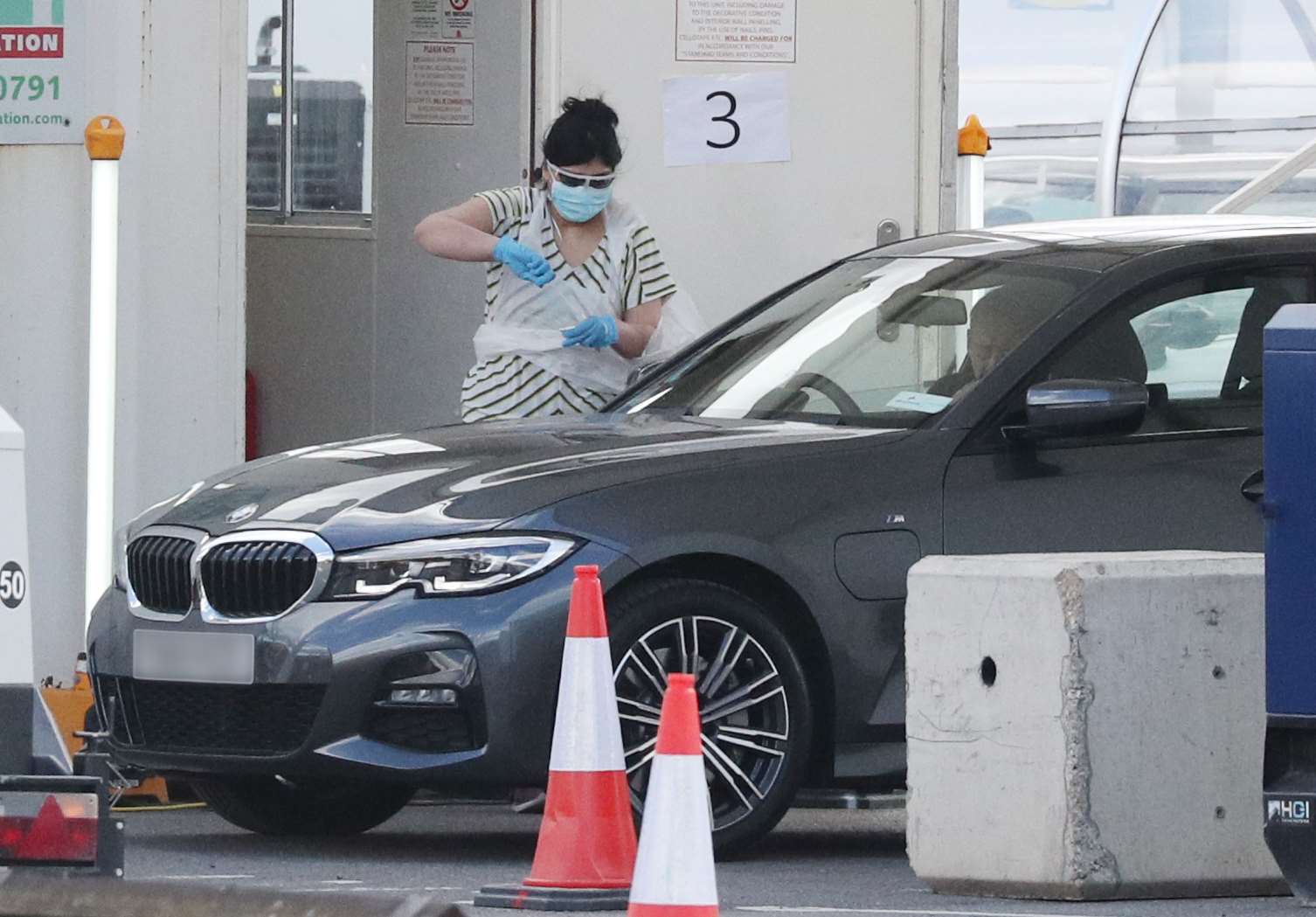 A person holds a swab at a Covid-19 drive-through test centre for NHS workers (PA)