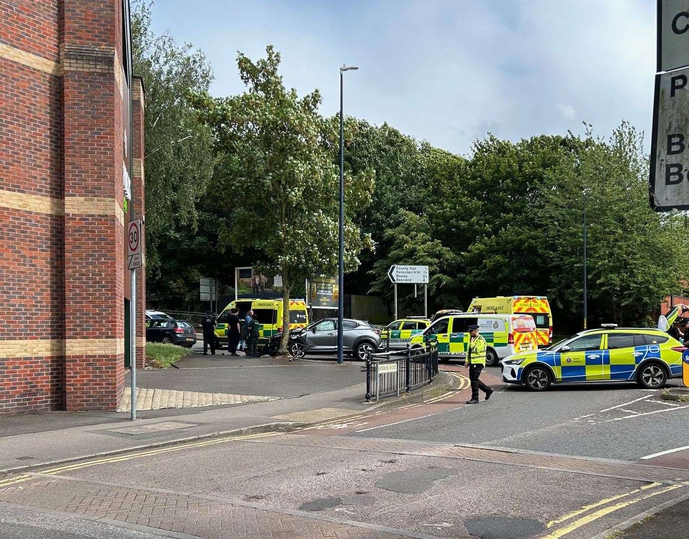 The car crashed through railings into a tree on a busy roundabout