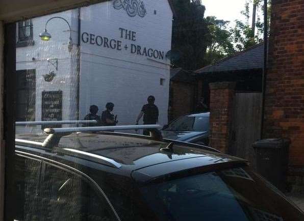 Armed police near the George and Dragon pub.