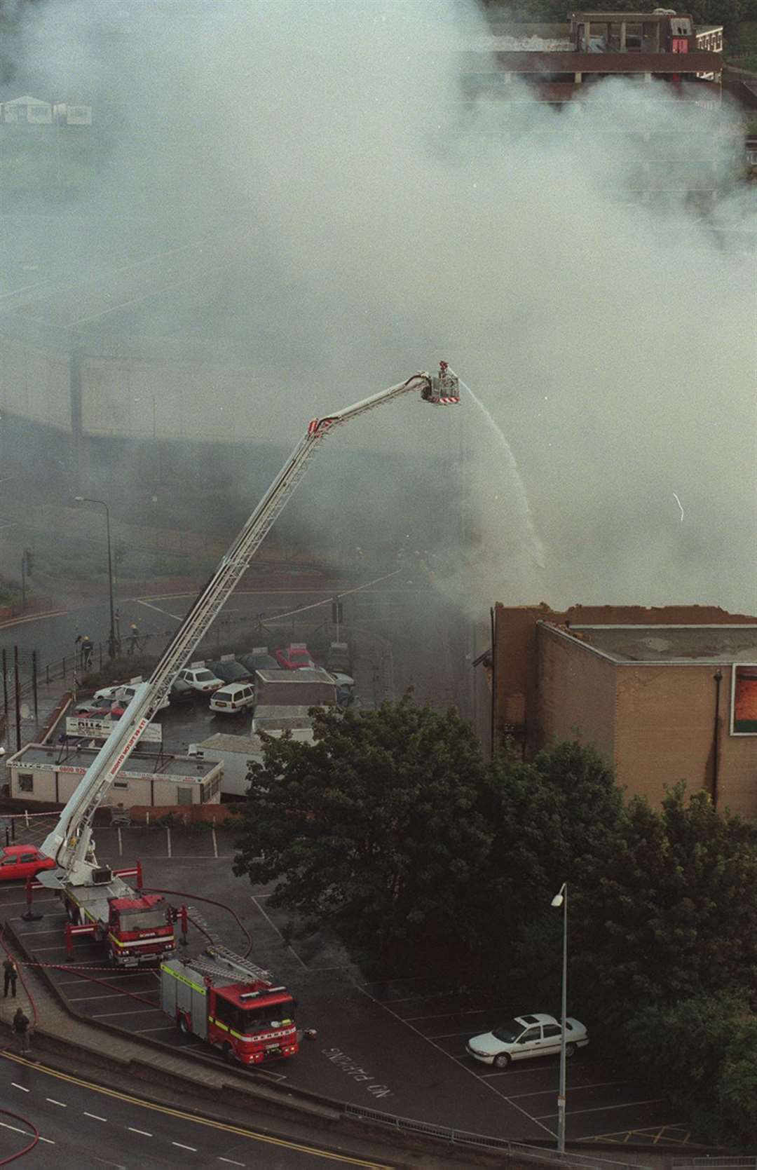 Fire crews try to douse the flames from a height vehicle but the building - which was in the process of being given listed status - was destroyed