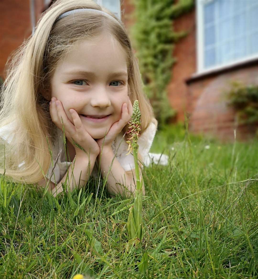 Alisa Djacenko with the rare orchid at the family home in Chatham. Photo: Angelika Djacenko