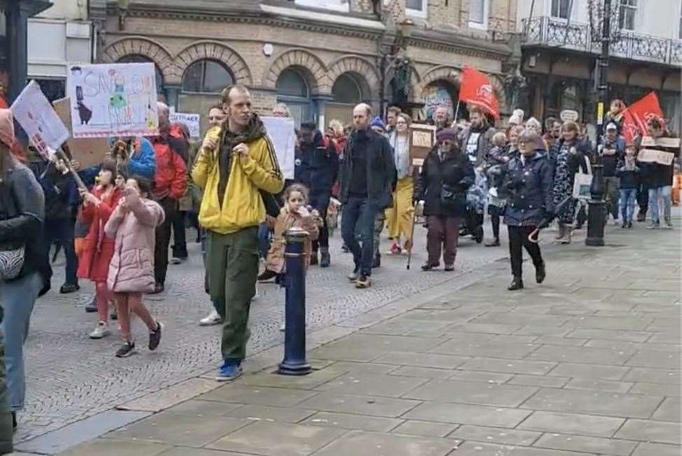 Marching down the town high street, demonstrators held placards and chanted 'Shame on KCC'