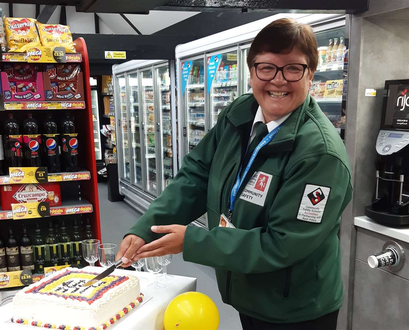 Community warden Jackie West cutting the cake at the relaunch. Picture: Post Office